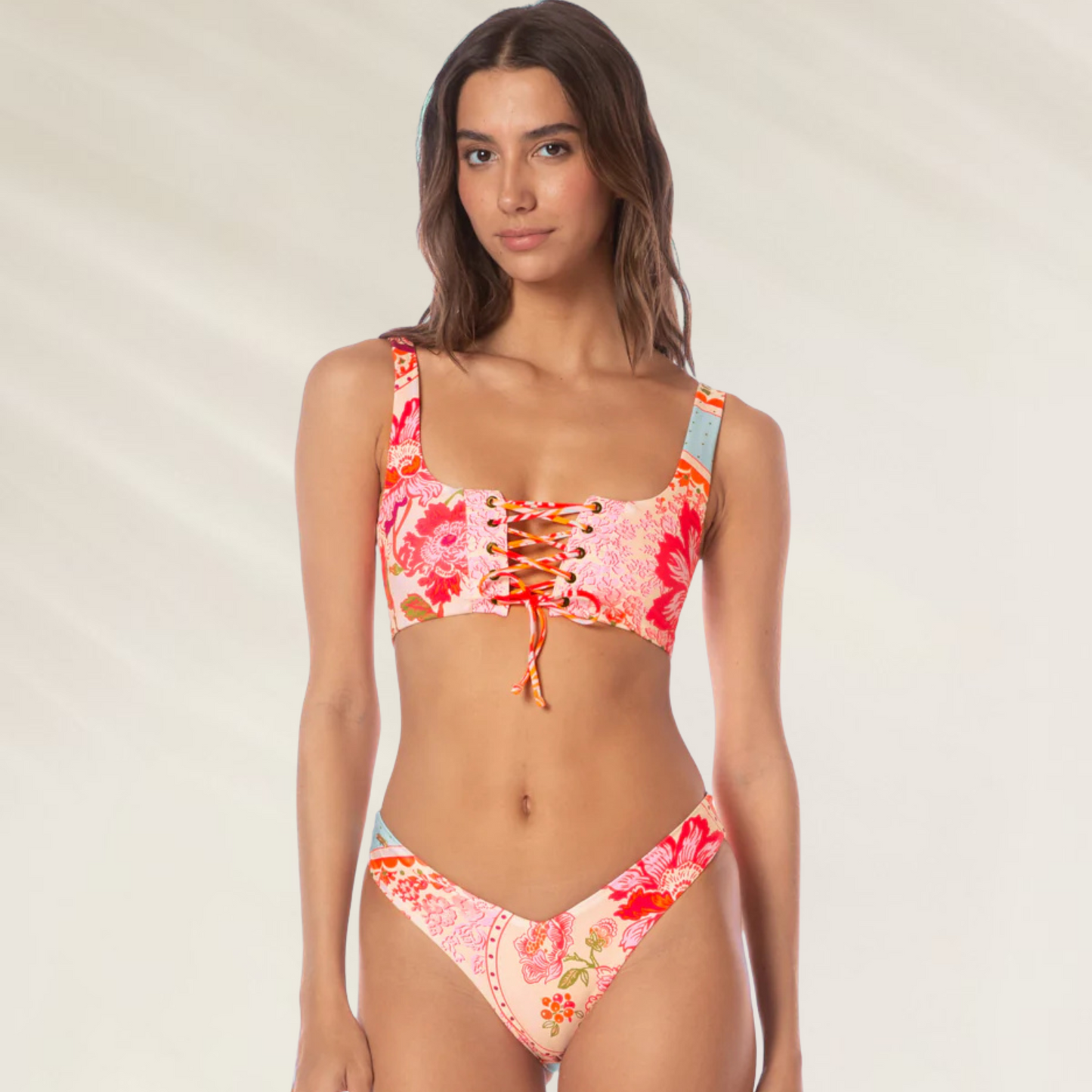 Mulher usando cueca reversível Valerya Maaji com estampa floral em tons de rosa e laranja