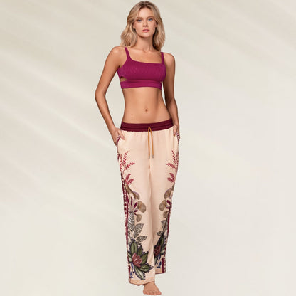Calças Kartel Solasta em tom nude com estampa floral vibrante e cós elástico, ideal para conforto e estilo