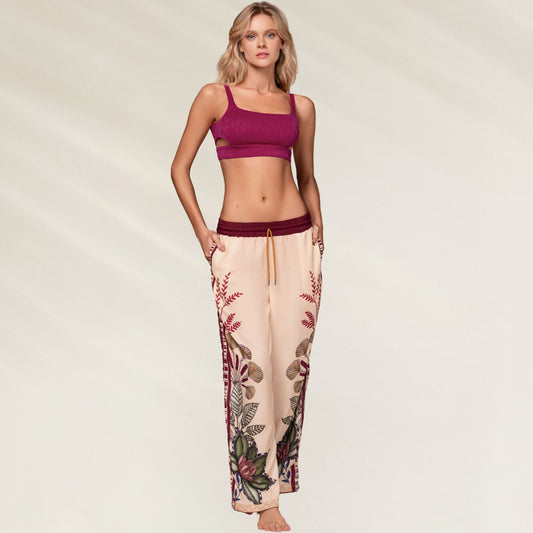 Calças Kartel Solasta em tom nude com estampa floral vibrante e cós elástico, ideal para conforto e estilo