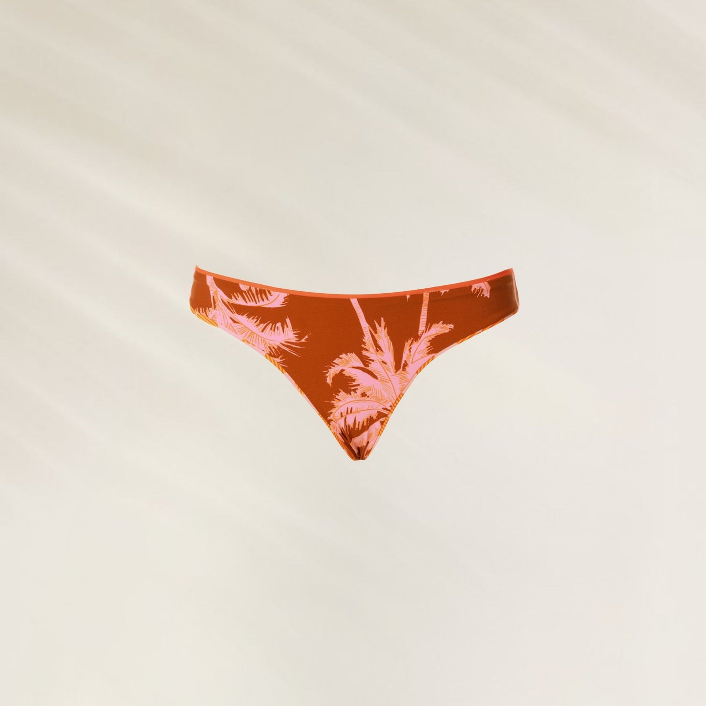Cueca de biquíni reversível Sunset Grid Flirt da Maaji em tom laranja com estampa de palmeiras