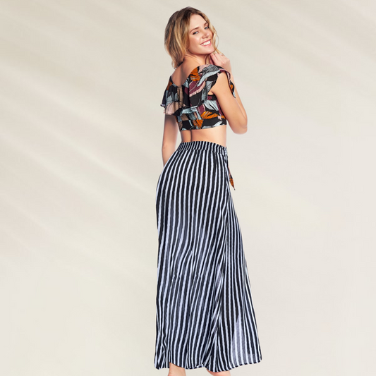 Mulher usando Saia Comprida às Riscas Maaji black and white listrada com blusa floral cropped