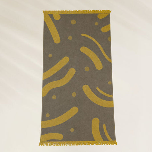 Toalha Golden Waves da Kalua com design moderno em fundo cinza e detalhes amarelos